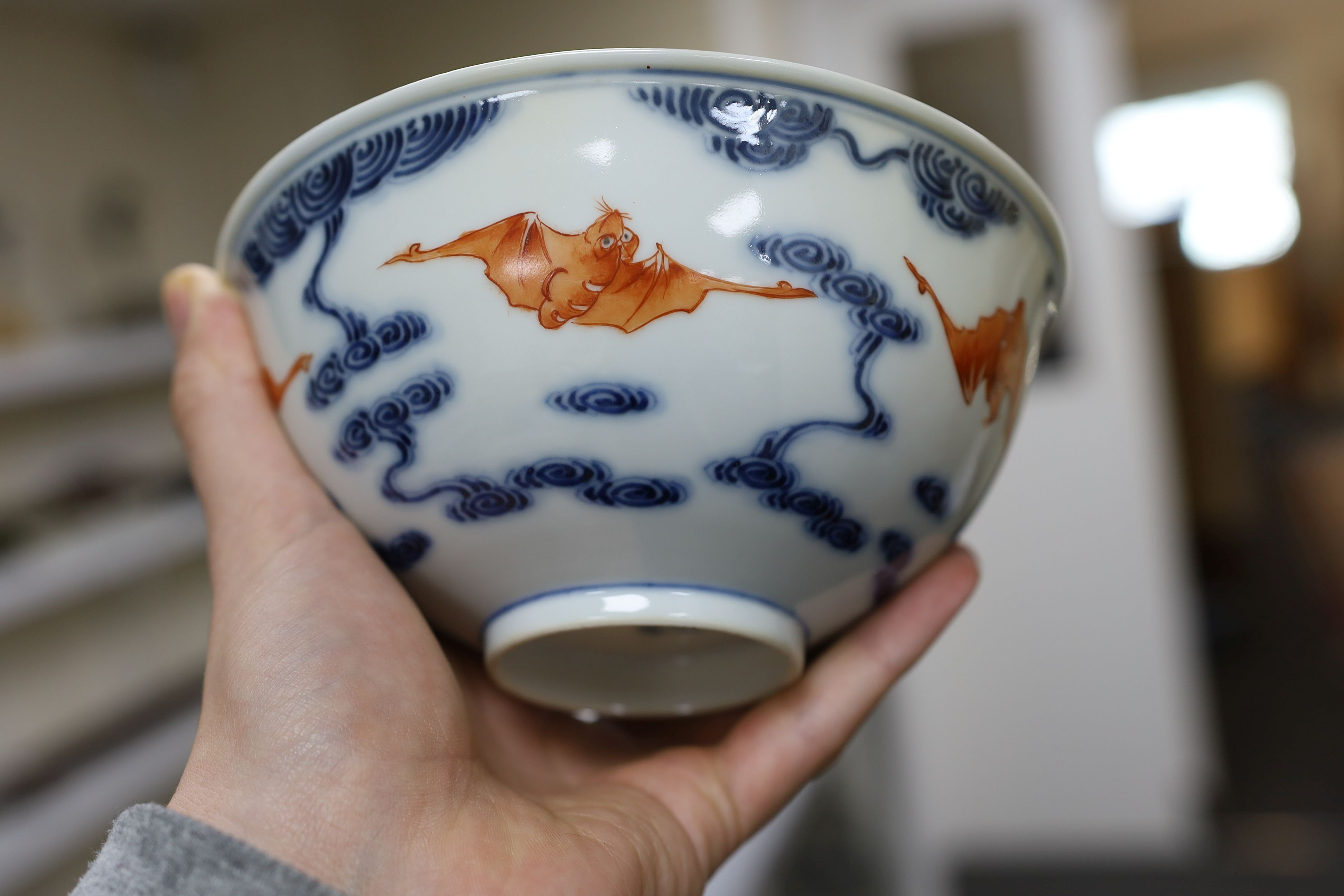 A pair of Chinese iron red and underglaze blue ‘five bat’ bowls, Guangxu mark and probably of the period (1875-1908), 16.5cm diameter
